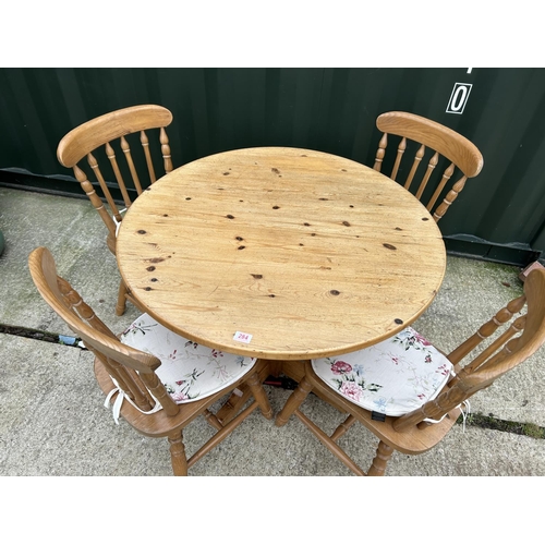 284 - A circular pine kitchen table together with four pine chairs 97cm diameter