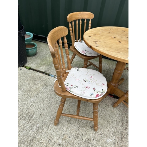 284 - A circular pine kitchen table together with four pine chairs 97cm diameter