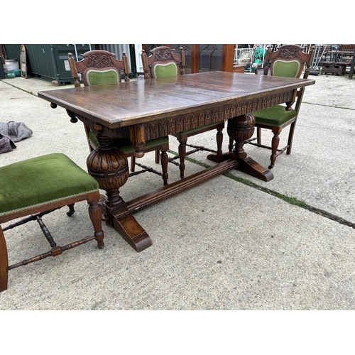 289 - A good quality extending oak dining table together with a set of six Edwardian green upholstered din... 