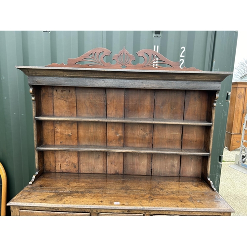 290 - An antique oak three drawer and three door dresser with removable platerack top 163x45x181