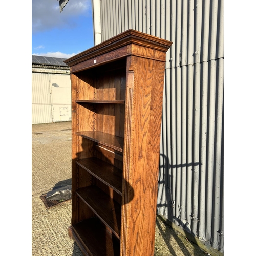 3 - A tall reproduction oak open fronted bookcase 207x30x100