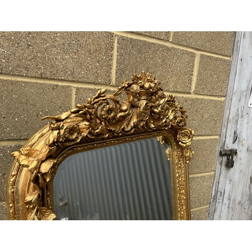 313 - A large ornate gold gilt mirror with cherubs to the top 80x160