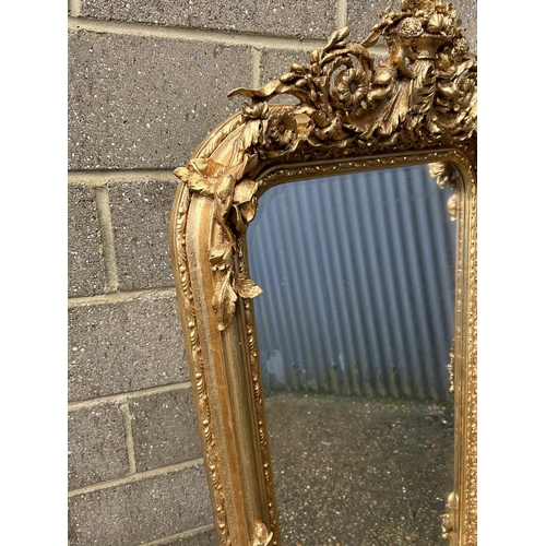 313 - A large ornate gold gilt mirror with cherubs to the top 80x160