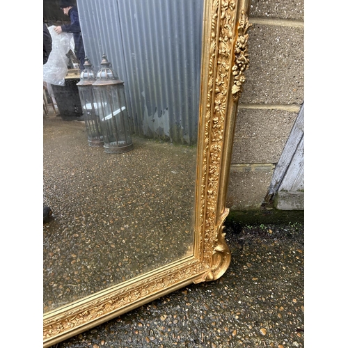 313 - A large ornate gold gilt mirror with cherubs to the top 80x160