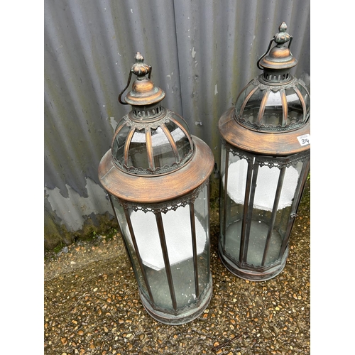 314 - A pair of copper effect metal and glazed candle lanterns 87cm tall