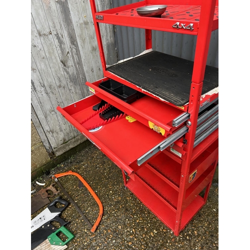 329 - A red workshop shelving unit fitted with three drawers, one drawer fitted with spanner set