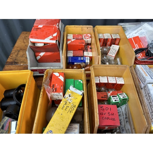 350 - Two crates containing parts, tubs of vintage car parts including dials, lucas bulbs, clips etc