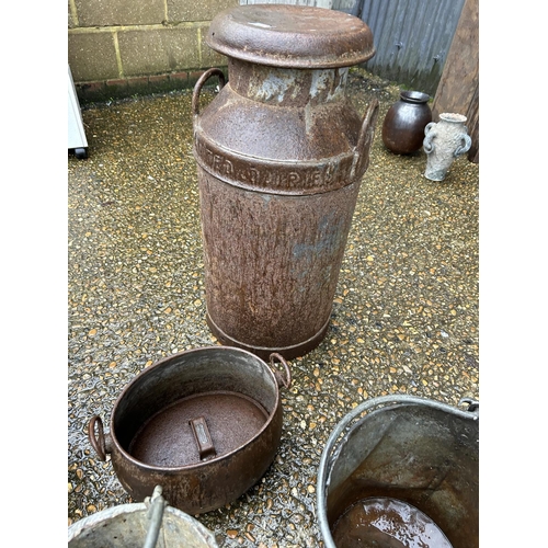72 - A vintage churn, four galvanised buckets, cauldron and feeder