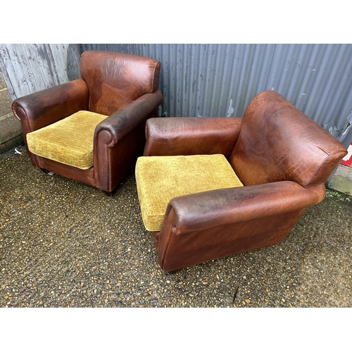 74 - A pair of brown leather club style armchair with gold upholstered cushions