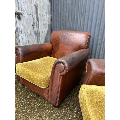 74 - A pair of brown leather club style armchair with gold upholstered cushions