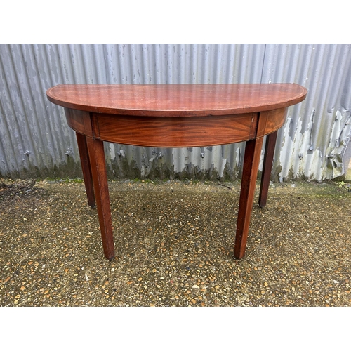 79 - A Victorian mahogany demi lune side table with drawer 120x64x77