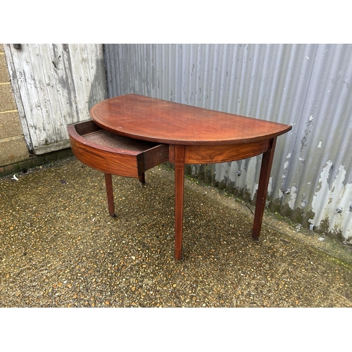 79 - A Victorian mahogany demi lune side table with drawer 120x64x77
