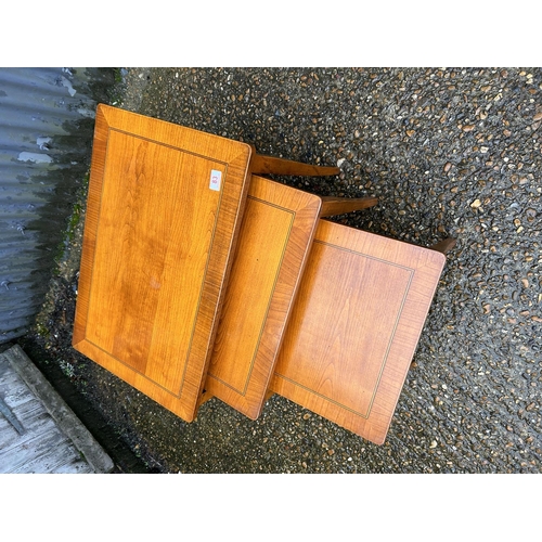 83 - A good quality yew nest of three occasional tables