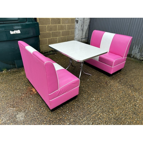 91 - An American diner style ali framed dining table with sparkle top together with two pink and white le... 