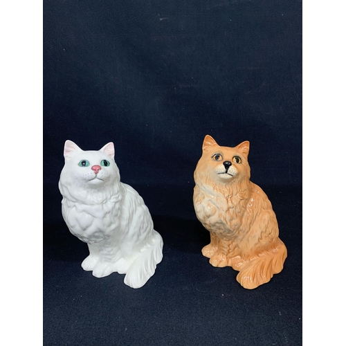 597 - 2 Doulton cat figures, height 21cms