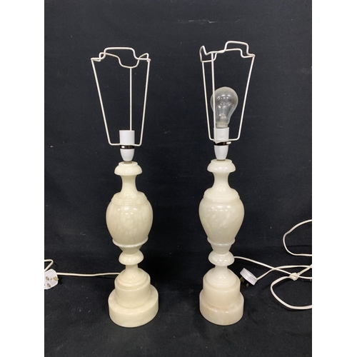 633 - Pair of heavy onyx lamp bases, height to top of base 41cms