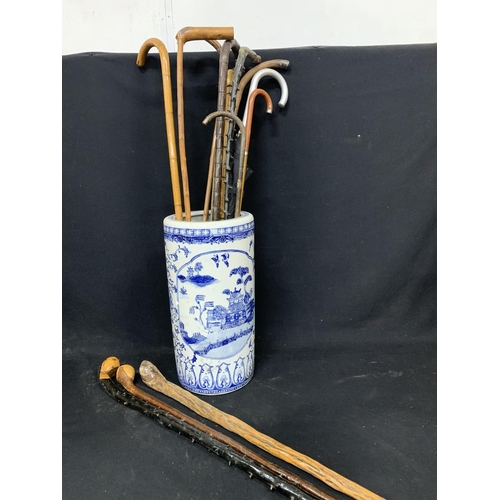 674 - 12 walking sticks with blue and white umbrella stand a/f