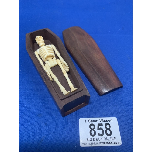 858 - Wooden Coffin contaning miniature bone human skeleton model, length 12 cms