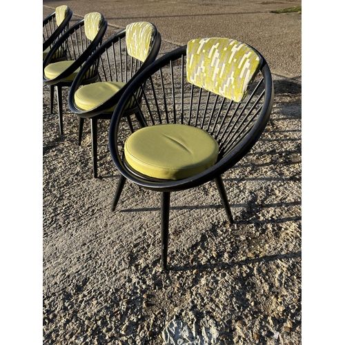 281 - A set of four Black stick back Vitra style designer chairs with Green Upholstery