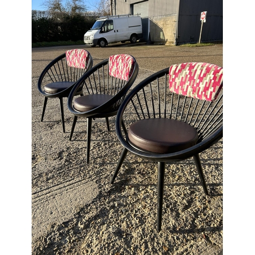 282 - A set of four Black stick back Vitra style designer chairs with pink Upholstery