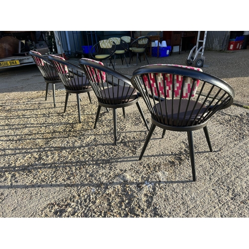 282 - A set of four Black stick back Vitra style designer chairs with pink Upholstery