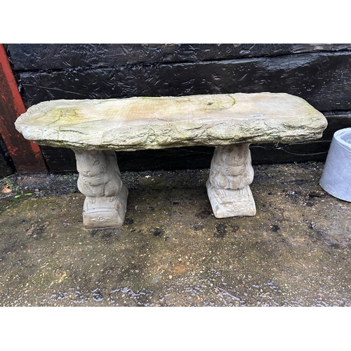 302 - A concrete log effect garden bench with squirrel supports