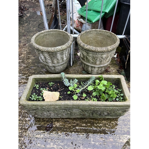 304 - A pair of ornate circular concrete garden urns together with a rectangular planter