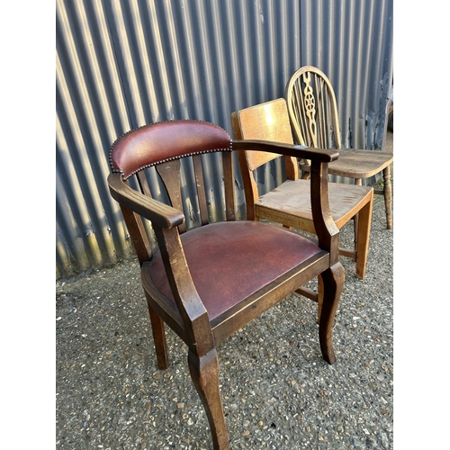 108 - An oak bow back desk chair together with a wheelback chair and a ply chair