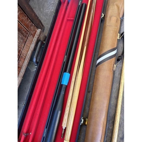 115 - A collection of snooker items including 2 cues, cue case, balls and racks