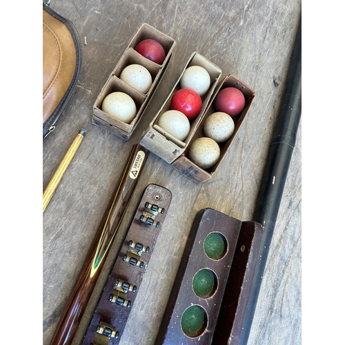 115 - A collection of snooker items including 2 cues, cue case, balls and racks