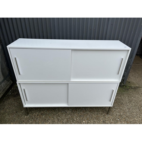 134 - A modern white gloss two section cupboard with sliding doors 150x40x127