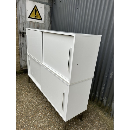 134 - A modern white gloss two section cupboard with sliding doors 150x40x127