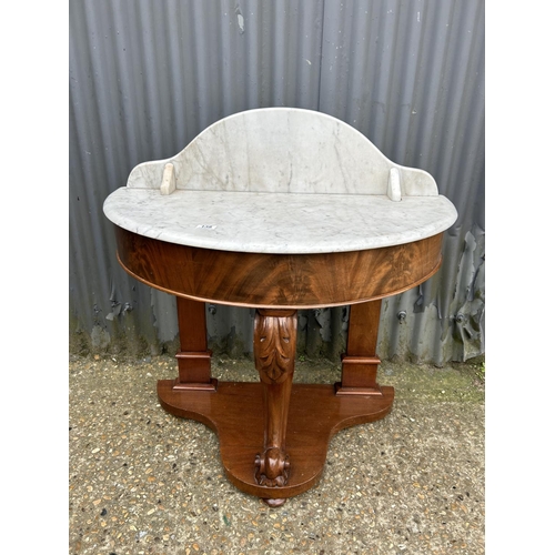 138 - A Victorian mahogany demi lune washstand with white marble top 90cm