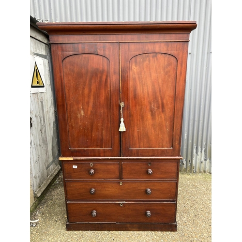 143 - A Victorian mahogany linen press with hanging top compartment over four drawer base 120x50x195