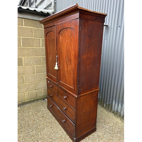 143 - A Victorian mahogany linen press with hanging top compartment over four drawer base 120x50x195