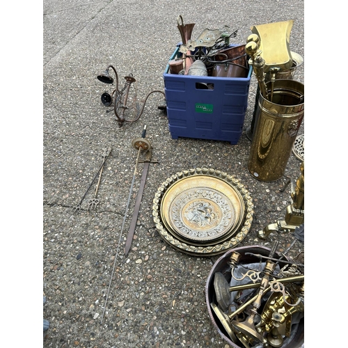 149 - A large collection of brass and copperware including small brass table, fire dogs, stick stand, tray... 