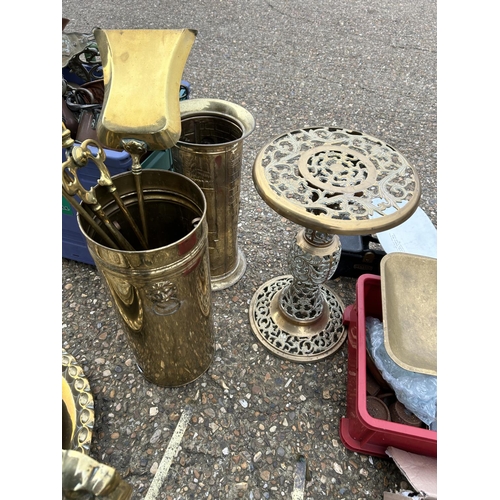 149 - A large collection of brass and copperware including small brass table, fire dogs, stick stand, tray... 
