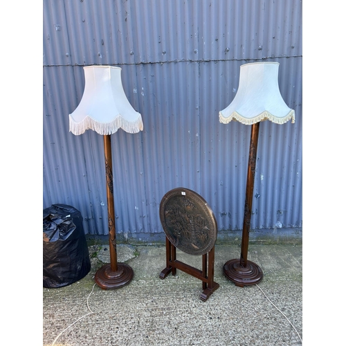 15 - A pair of oriental carved standard lamps with shades (and additional shades) together with a tilt to... 