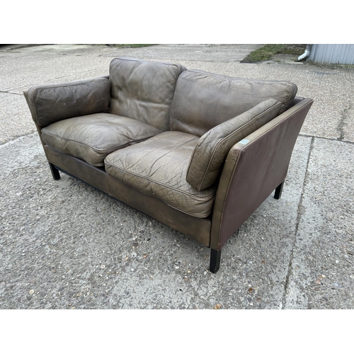 173 - A danish style brown leather two seater sofa