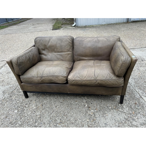 173 - A danish style brown leather two seater sofa
