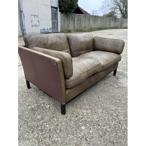 173 - A danish style brown leather two seater sofa