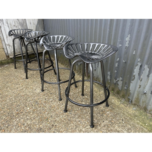 184 - A set of four metal swivel adjust tractor seat bar stools