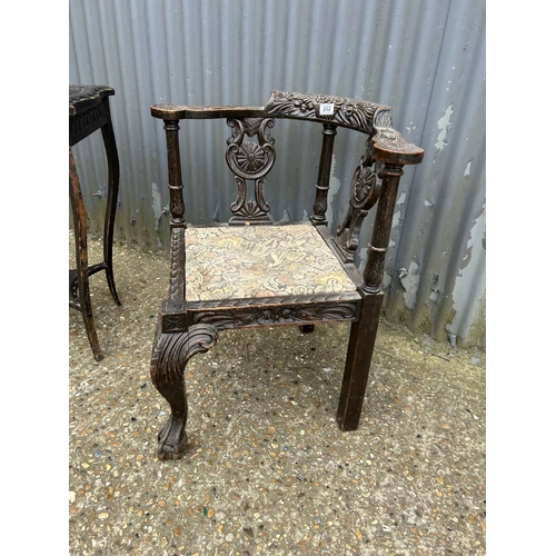202 - A carved oak corner chair together with a carved occasional table