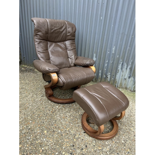 211 - A brown leather reclining chair with stool by HIMOLA