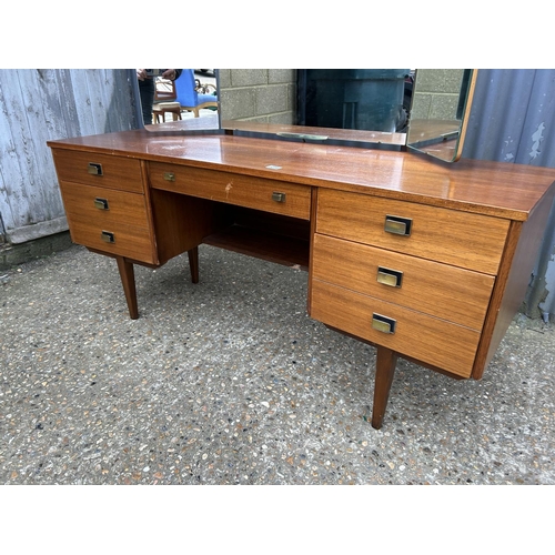 214 - A mid century teak dressing table / kneehole desk