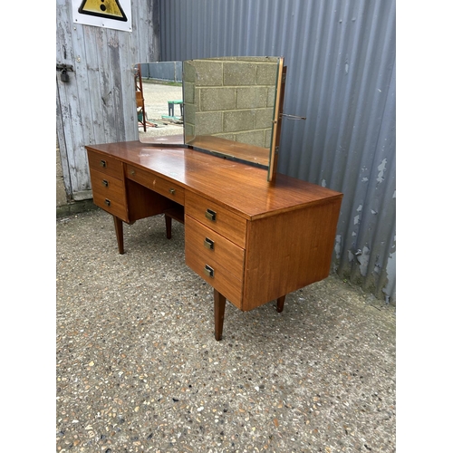 214 - A mid century teak dressing table / kneehole desk