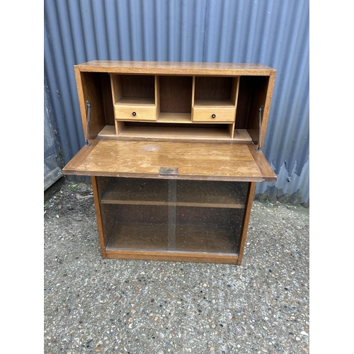 218 - An early 20th century oak bureau cabinet with drop down front and fitted interior 77x27x100