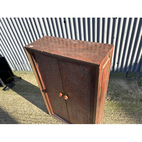 22 - A  Flemish red and gold painted two door cupboard 76x30x120