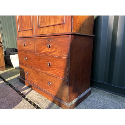 242 - A Victorian mahogany linen press, with a top section fitted with three slides over a four drawer bas... 