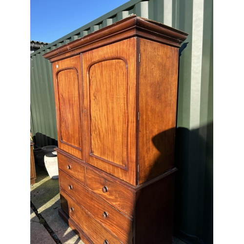 242 - A Victorian mahogany linen press, with a top section fitted with three slides over a four drawer bas... 